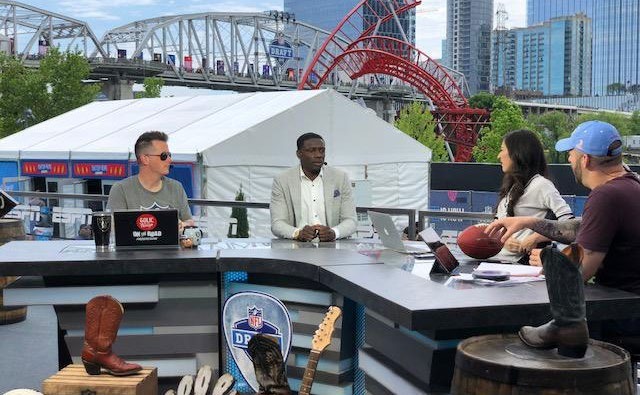 Darius Butler at a live draft-day broadcast desk