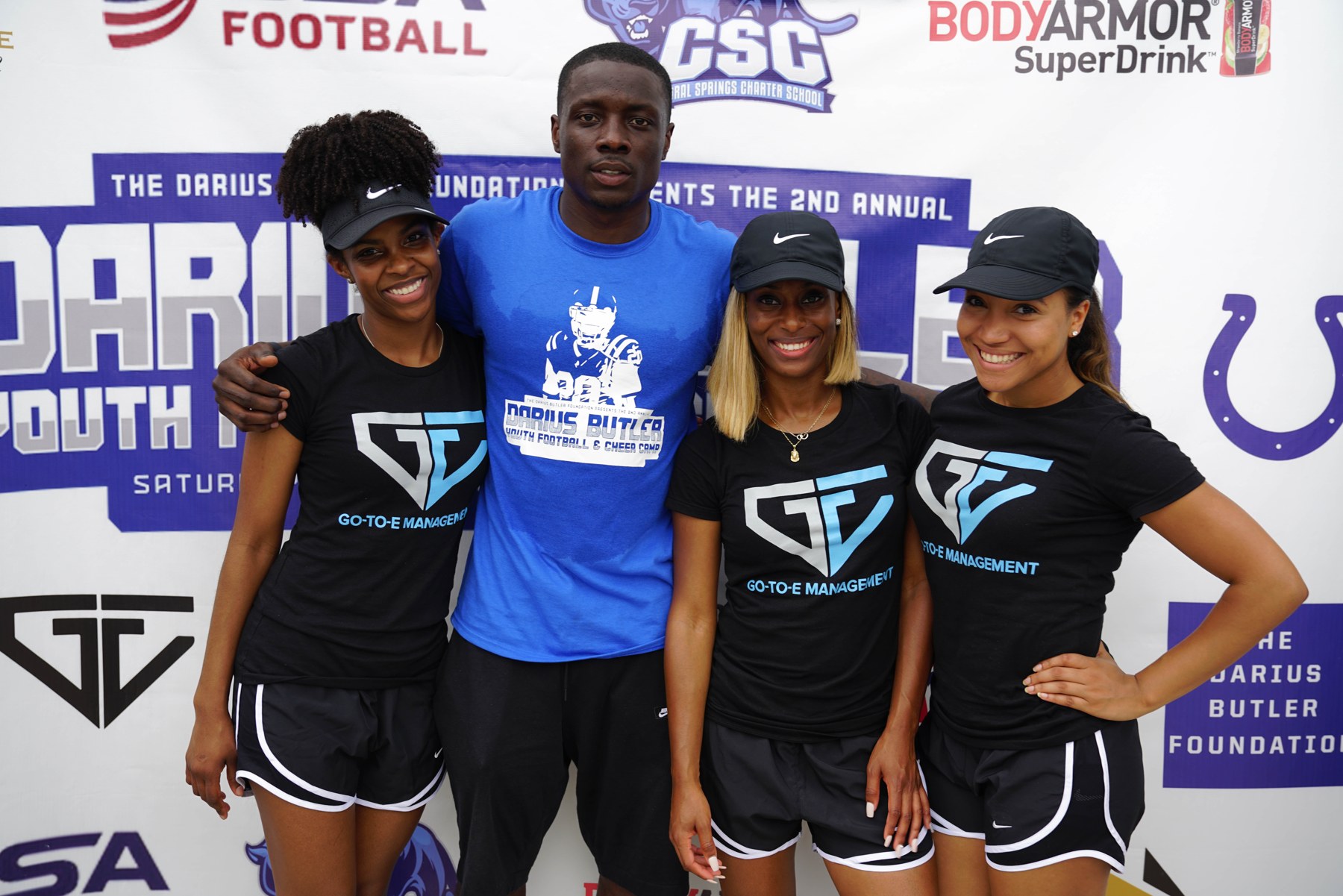 Erika Sykes and the GO-TO-E team with Darius Butler at his youth football and cheer camp