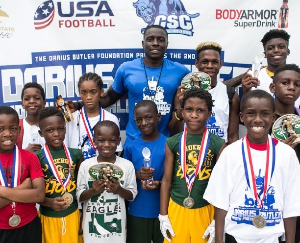 Darius Butler with young camp participants and their medals